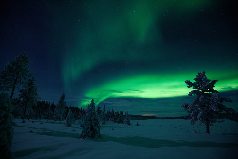 Northerlights over snowy landscape